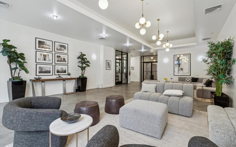 a room with a couch and chairs